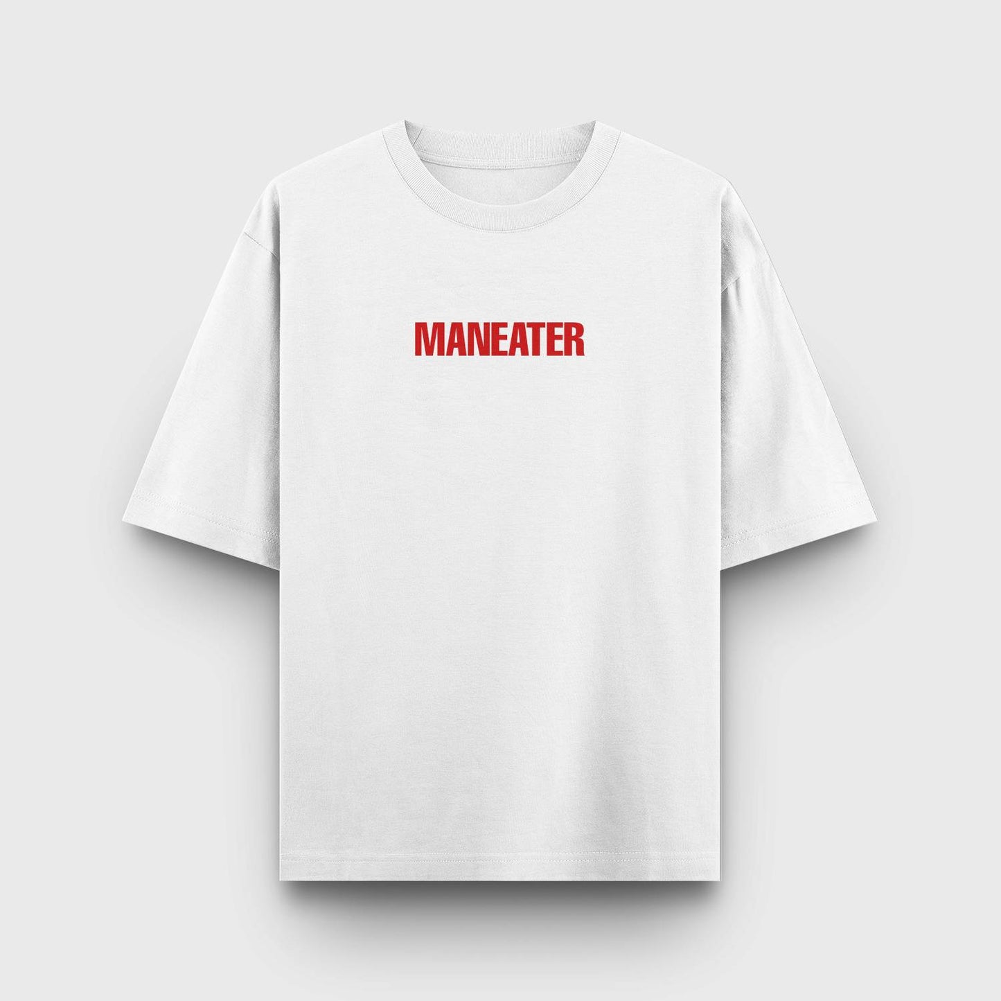 White t-shirt with bold red "MANEATER" text in a minimalist design.