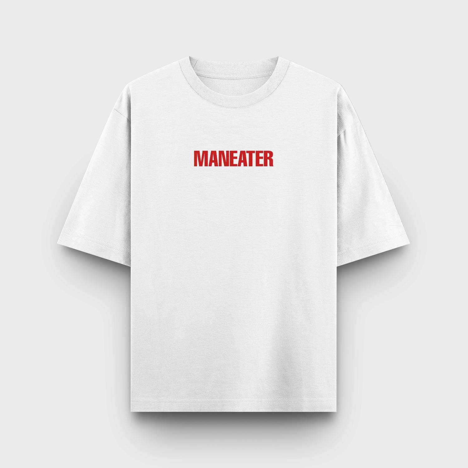 White t-shirt with bold red "MANEATER" text in a minimalist design.